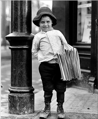 Old-fashioned newsboy on a streetcorner