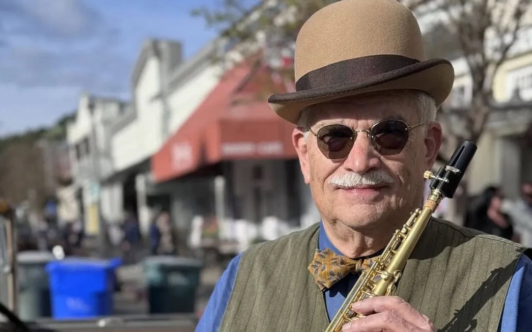 Artist Don Neely With A Brown Top Hat And Saxophone