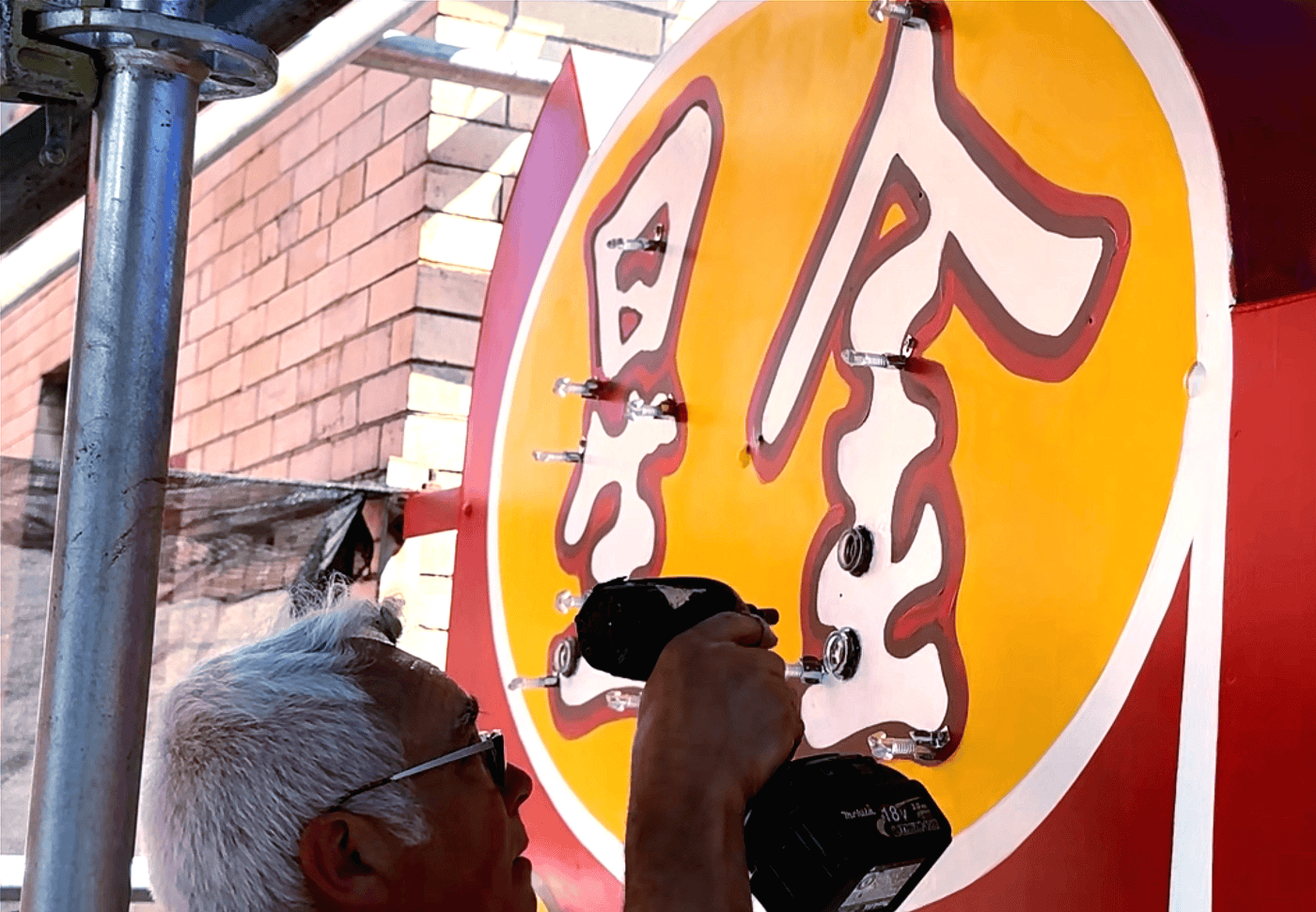 Jim Rizzo Installing Glass Supports For Neon On The Golden Star Radio Sign