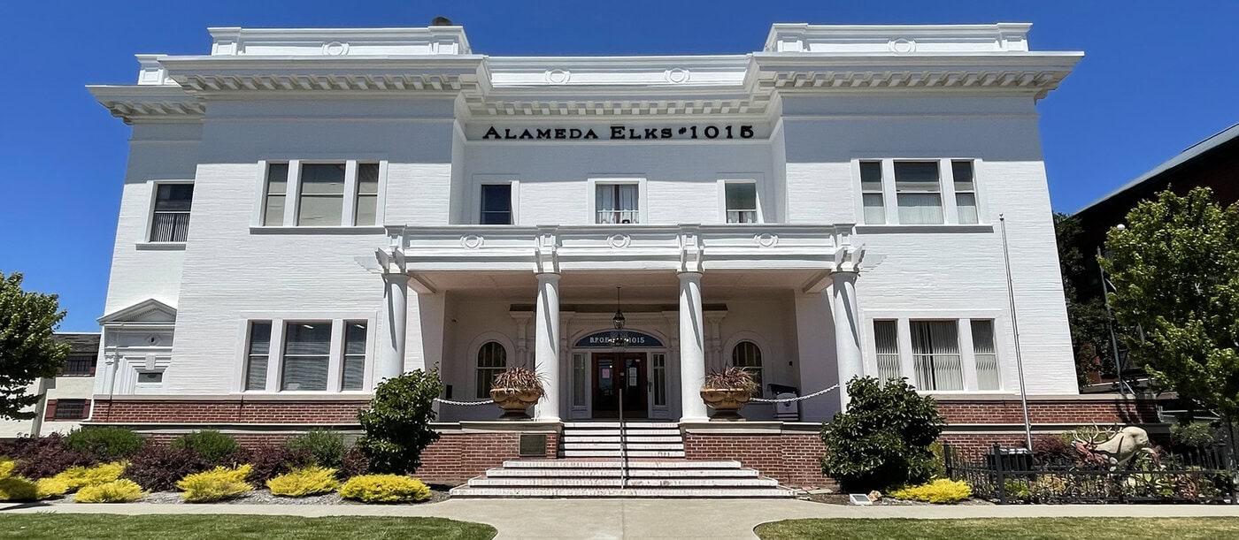 Image Of The Exterior Of The Alameda Elks Lodge. A White Building On Santa Clara Ave.