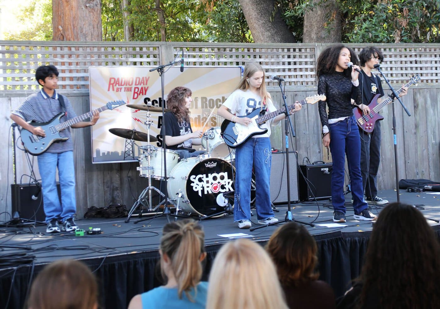 Radio Day School Of Rock Band With Kids Playing Guitar, Drums, And Singing