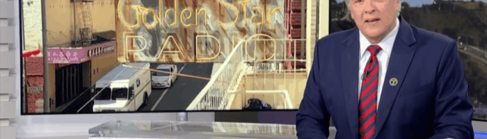 ABC7 anchor Dan Ashley presenting a story about the Golden Star Radio sign restoration