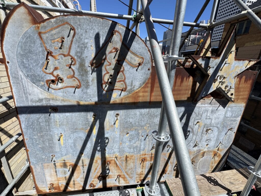 Golden Star Radio Sign With Neon Removed, Revealing Faded Paint And Weathered Metal