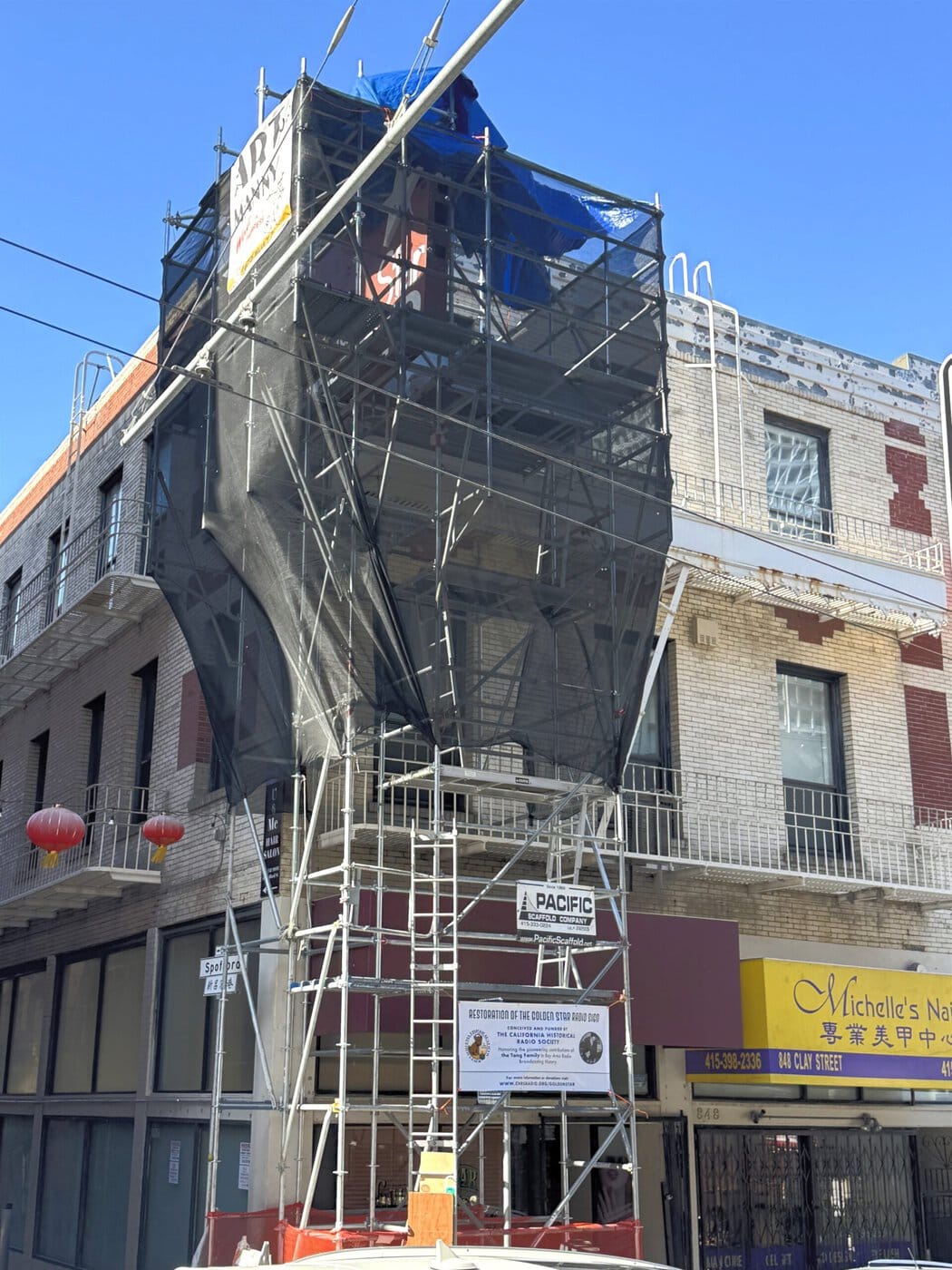 Three Stories Of Scaffolding Surrounding The Golden Star Radio Sign During Restoration In San Francisco'S Chinatown